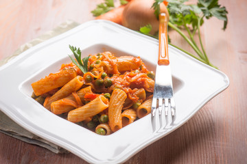 pasta with vegetables ragout and peas, selective focus