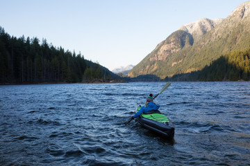 Girl Kayaking in a Lake. Taken in Buntzen Lake, Vancouver, British Columbia, Canada.