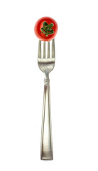 Image of red cocktail tomatoes on fork. Concept of vegetarian food