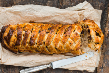 Pork roll - spicy sausage meat with chillies and beans in puff pastry