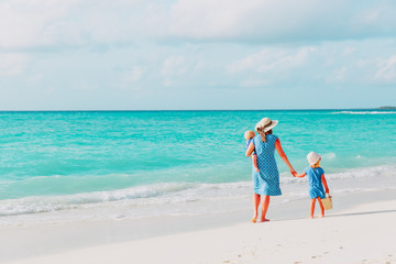 family on beach vacation-mother with two kids at sea