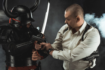 armored samurai fighting with modern man in shirt who holding gun