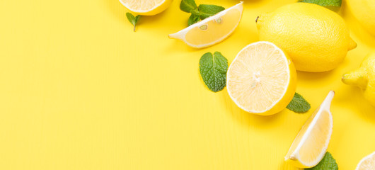 on a yellow background, sliced into slices of lemon, and fresh mint