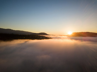 Aerial view of the fog covering North Vancouver, British Columbia, Canada, during a vibrant sunrise