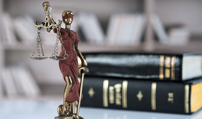 Law and Justice concept. Mallet of the judge, books, scales of justice. Gray stone background, reflections on the floor, place for typography. Courtroom theme.