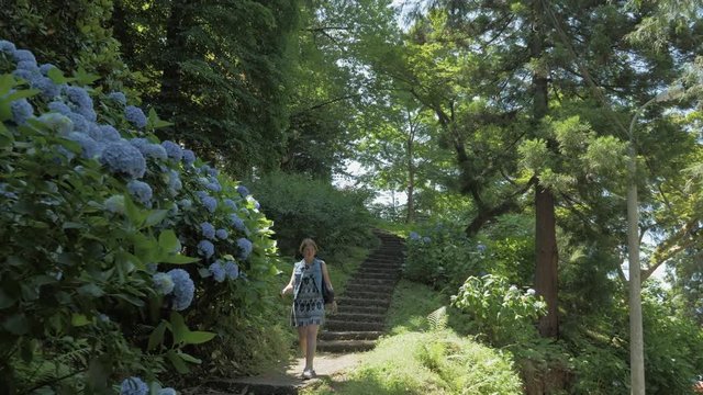 Young girl walking in tropical botanical garden. Batumi, Georgia
