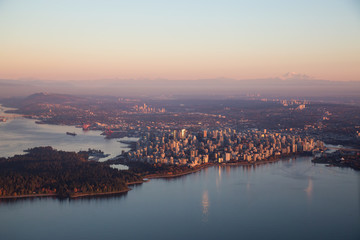 Fototapeta premium Aerial view of Downtown City during a colorful and vibrant sunset. Taken in Vancouver, British Columbia, Canada.