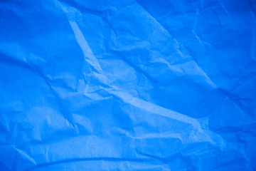 Obraz premium Crumpled blue paper background.