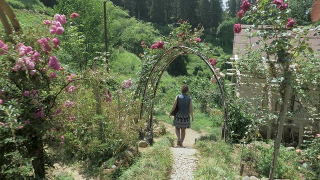 Young girl walking in tropical botanical garden. Batumi, Georgia