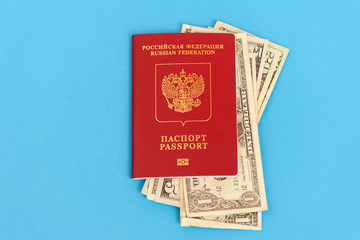 Globe and Russian passport with dollars banknote on blue background