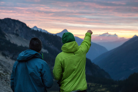 Couple Adventurous Friends Are Hiking In The Wilderness On Rocky Mountain Terrain. Taken Northeast Of Seattle, Washington, United States Of America.
