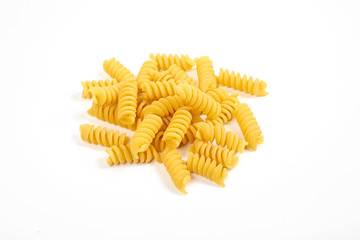 uncooked fusilli pasta noodles isolated on white background