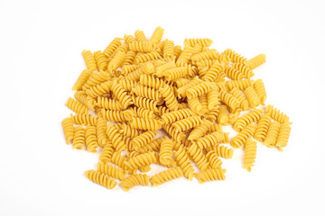 uncooked fusilli pasta noodles isolated on white background