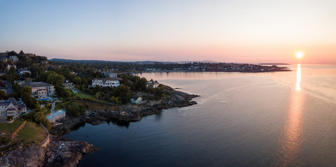 Aerial panoramic view of the luxury homes on a rocky Pacific Ocean Shore during a vibrant summer...