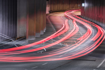 Light trails of cars in the winding tunnel