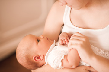 Obraz na płótnie Canvas Baby lying in mother hands close up. Motherhood. Maternity.