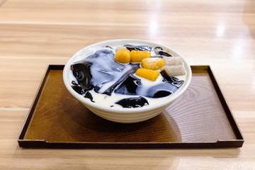 Taiwanese dessert made from grass jelly, topped with milk