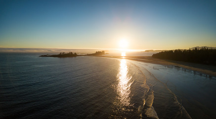 Aerial panoramic view of the beautiful Pacific Ocean Coast during a vibrant summer sunset. Taken near Tofino, Vancouver Island, British Columbia, Canada.

