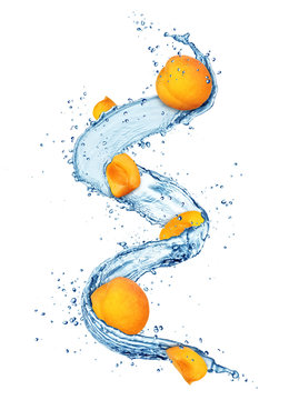 Pieces of apricots in water splashes isolated on white background
