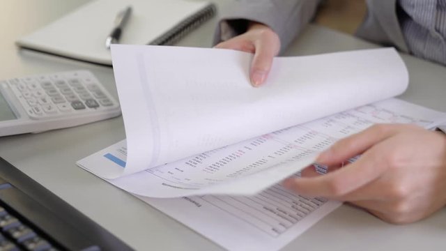 people flipping financial statements paper
