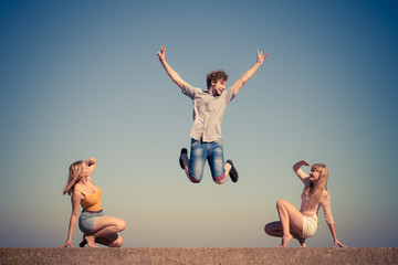 Group of friends boy two girls relaxing outdoor