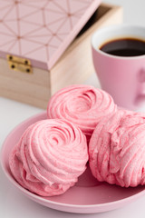 Obraz na płótnie Canvas Homemade pink zephyr or marshmallow with coffee on white background