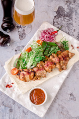 top view delicious Bbq meat with vegetables, sauce spices chile on gray concrete background. with ketchup on white plate, view from above with beer and Chile spices