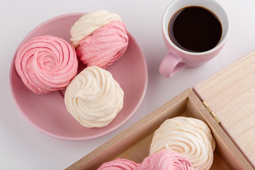 Obraz na płótnie Canvas Homemade zephyr or marshmallow with coffee on pink background