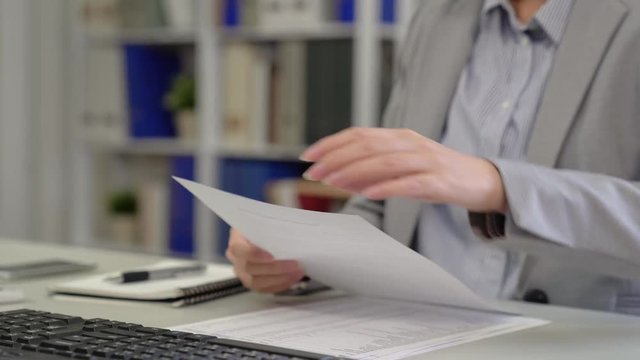 Overloaded senior businesswoman tearing papers