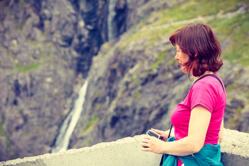 Naklejka premium Tourist woman on Trollstigen viewpoint in Norway