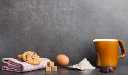 chocolate chip cookies with ingredients on a stone kitchen table