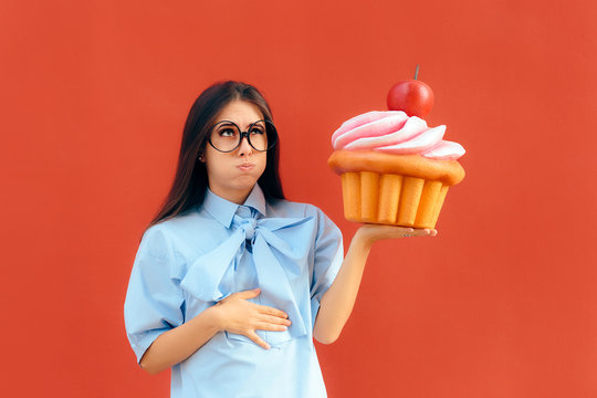 Woman Suffering Stomach Ache After Eating Too Much Cupcake 