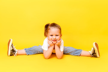 Adorable stylish girl posing on yellow color background