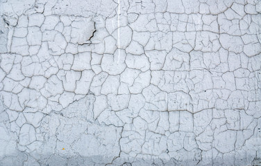 Texture cracked white paint on a stone wall.