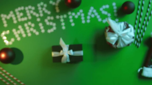 Man takes picture of his Christmas gift on cellphone camera on decorated table with chroma key, top down shot