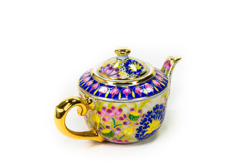 A tea pot made of Thai earthenware on a white background.