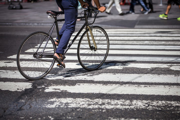 Fototapeta na wymiar Man on a bike on a crossing in Manhattan, NYC