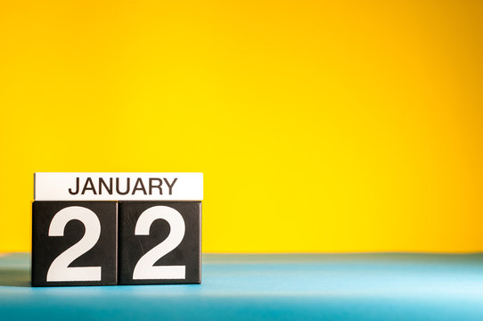 January 22nd. Day 22 of january month, calendar on yellow background. Winter time. Empty space for text