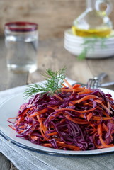 Salad with red cabbage and carrots in a plate