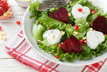 Fresh salad with goat cheese, roasted beets and lettuce. Valentine's day