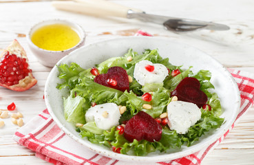 Valentine's day. Fresh salad with goat cheese, roasted beets and lettuce