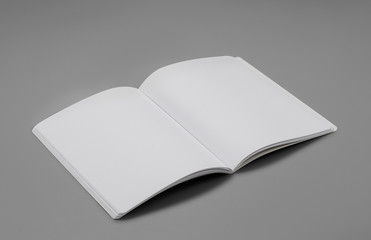 Mock-up magazine, book or catalog on gray table. Blank page or notepad on solid background. Blank page or notepad for mockups or simulations.