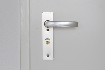 White door with old chrome doorhandle