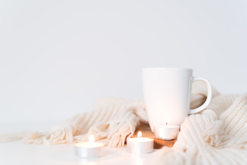 Fototapeta na wymiar Cozy shot with white mug and candles