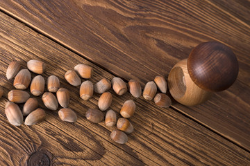 .hazelnuts and nutcracker on a wooden background