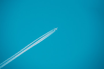 Airplane In The Sky With Plane Trails