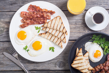 Breakfast with eggs bacon and toasts