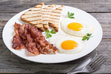 Breakfast with eggs bacon and toasts