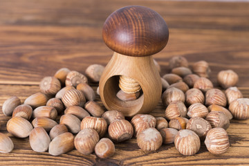 .hazelnuts and nutcracker on a wooden background
