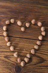 .hazelnuts and nutcracker on a wooden background